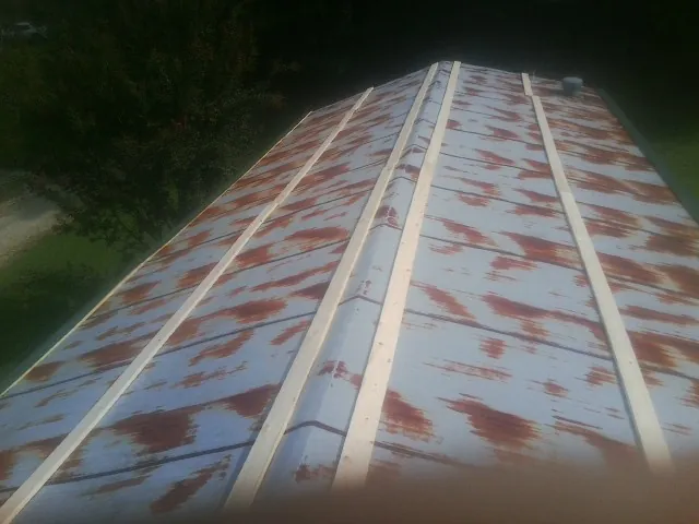 Rusted metal roof panels with new wood purlins before replacement — Storm Damage Roof Repair in Gibbonsville by Roofing Brothers