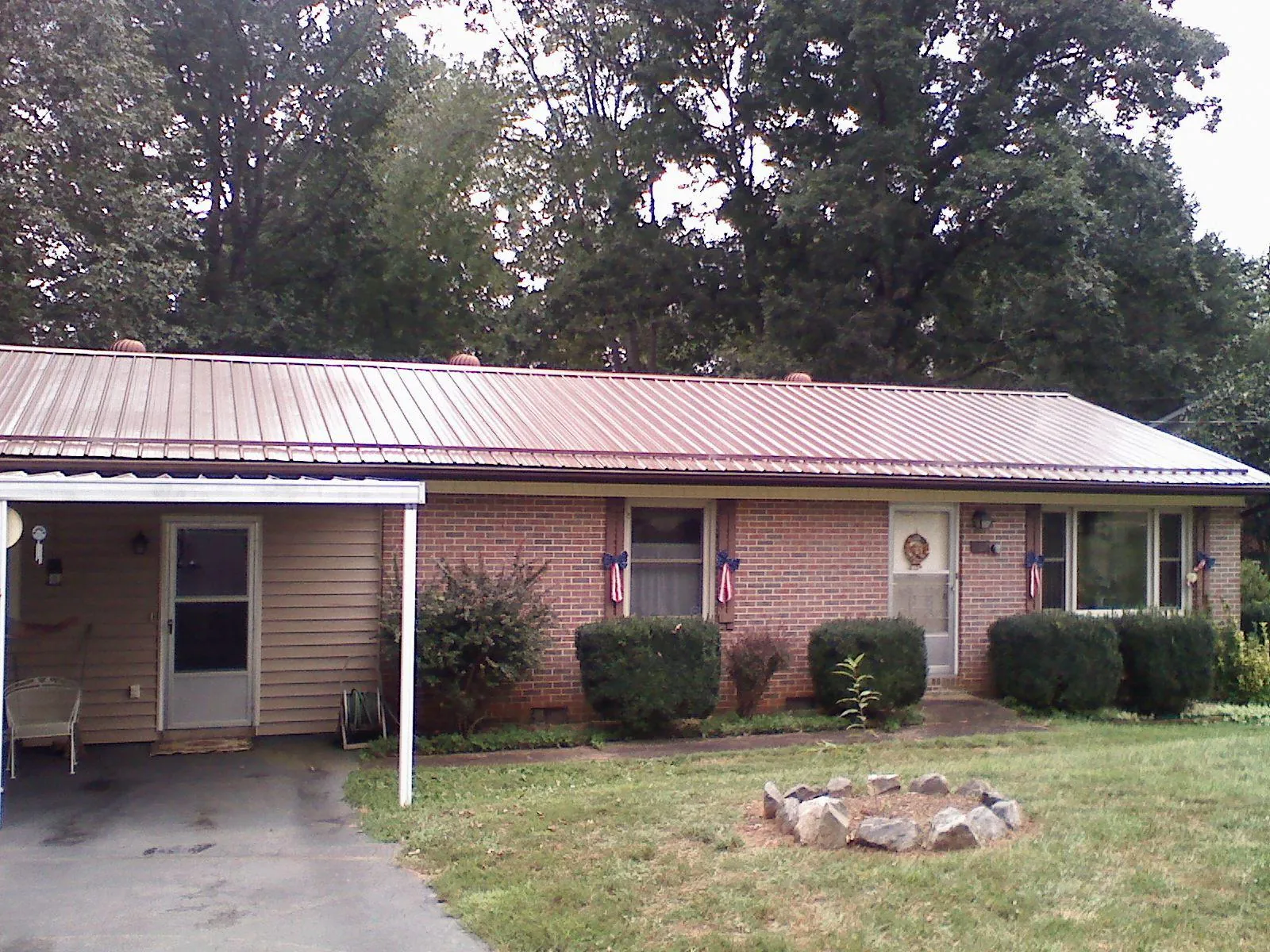 Bronze metal roof and carport on a brick ranch home — Roof Repair work by our crew in Gibbonsville