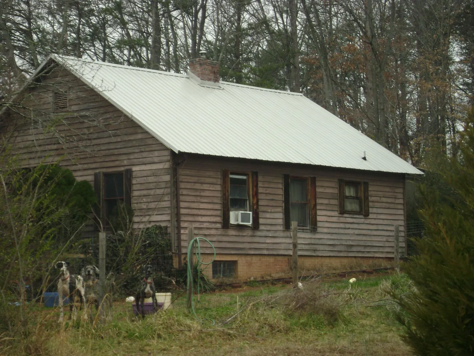 White metal roof on an old wood sided farmhouse, from a Metal Roof Installation job in Gibbonsville